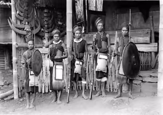 Suku Ngada — Men of the Ngadatribe in warriorscostume with lances, rifles and shields, Flores.