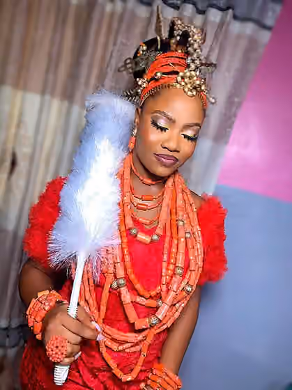Esan people — The Esan, Ishan speaking people and Benin people of Edo state, South-South Region of Nigeria in West Africa are famous for their okuku head gear and velvet red dress or wrapper as seen on this beautiful bride.