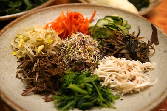 namul — An plate of namul (sauteed vegetables) for bibim ssambap (a variant of bibimbap and ssambap ) at a restaurant in [Gyeongju], North Gyeongsang province , South Korea