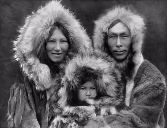 Iñupiat — A family portrait of an Inupiat Eskimo mother, father, and son.
