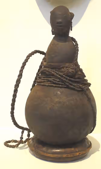 Mbugu people — Shaman's stoppered gourd vessel, Mbugu people, northeast Tanzania, late-19th-early 20th century, gourd, beads, fiber, metal, patina, Honolulu Museum of Art accession 2015-1-01