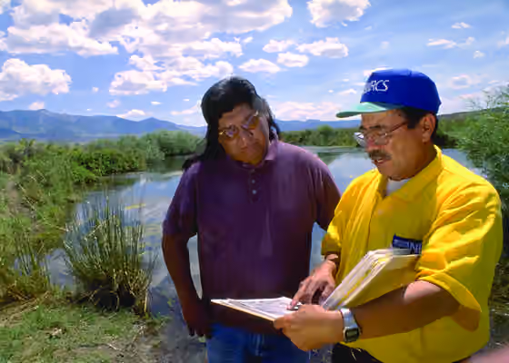 Goshute — Milton Hooper (left), Environmental Specialist at the Goshute Indian Reservation, and Carlos Garcia, NRCS, review a riparian management plan for the reservation.
