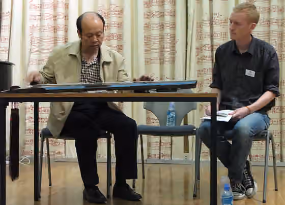 Shu school — Master Zeng Chengwei plays qin (Joshua Wickerham is the translator on the right)