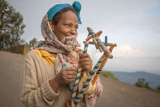 Semsemiah — Egyptian woman holding a pair of Egyptian simsimiyya lyres.