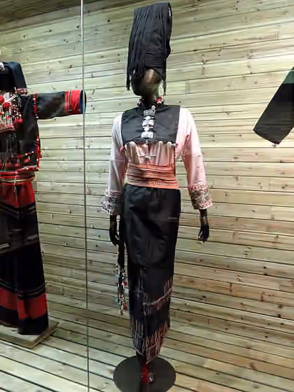 orang Achang — Achang woman brocade dress.
